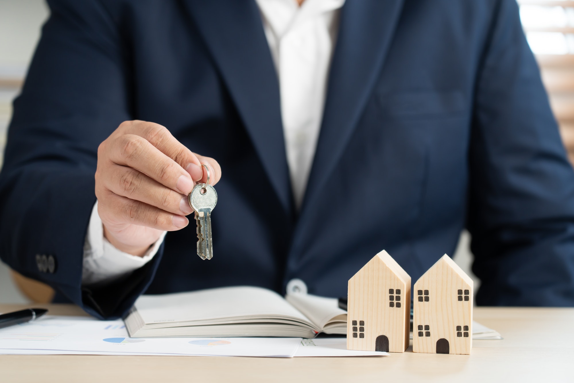 Real estate agent broker or realtor with house and contract plan document paper